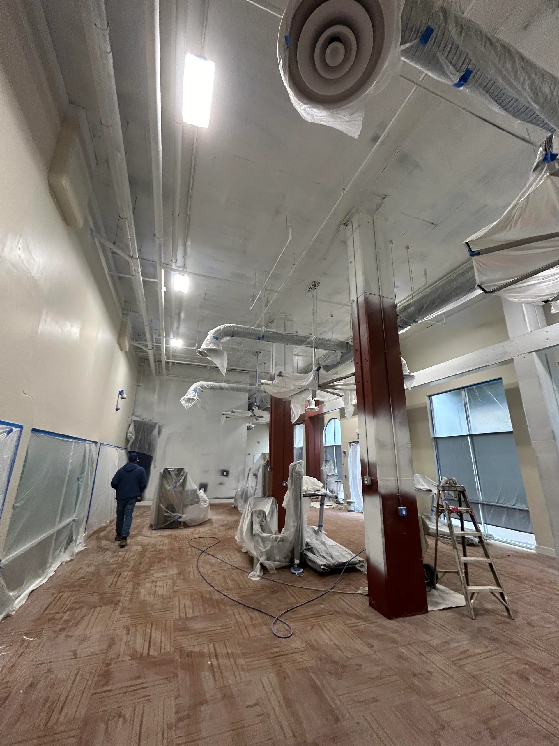 Large commercial interior masked and prepped for painting